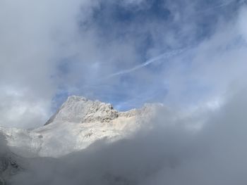 Low angle view of snowcapped mountain against sky