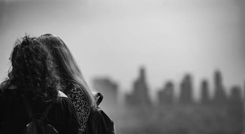 Female friends against sky