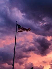 Low angle view of flag against sky during sunset