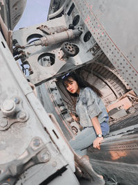 Portrait of young woman sitting in city