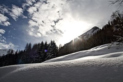 Scenic view of snow covered mountains against sky