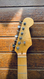 High angle view of guitar on wooden table