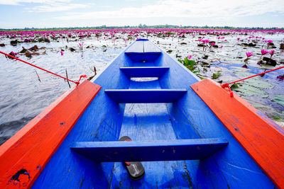 Close-up of boat moored on lake