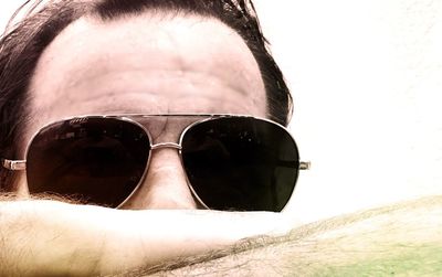 Low angle view of man wearing sunglasses against sky