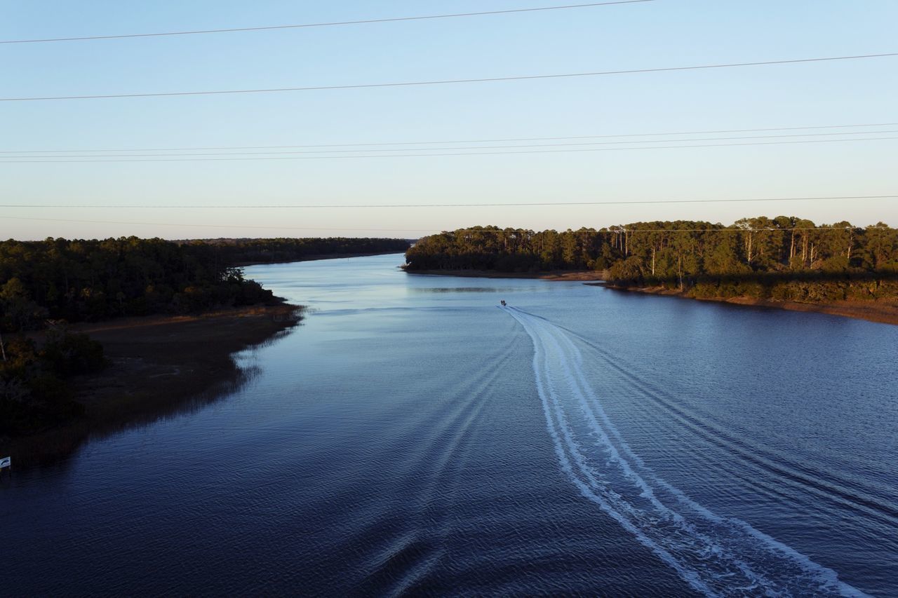 water, tranquil scene, tranquility, scenics, beauty in nature, clear sky, nature, blue, sky, lake, reflection, tree, landscape, river, rippled, idyllic, day, calm, outdoors, no people