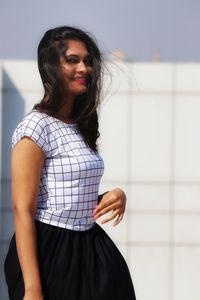 Beautiful young woman standing at home