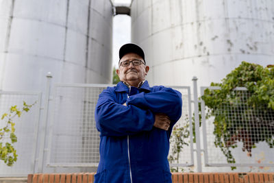 Full length of man standing against wall