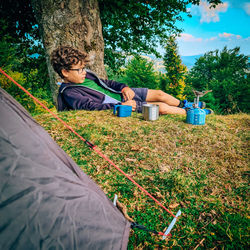 Rear view of people sitting on land