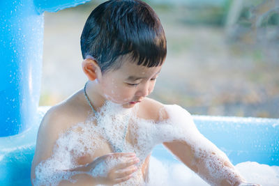 Full length of shirtless boy in swimming pool