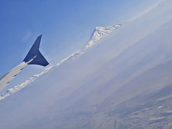 Aerial view of snowcapped mountain against sky