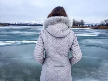 Woman standing on frozen lake