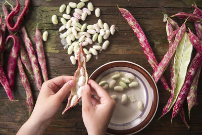 Close-up of hand shelling beans