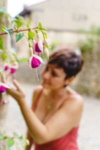 Side view of woman holding flowers