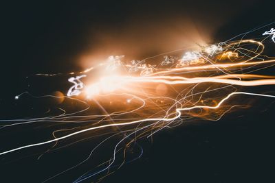 Close-up of illuminated light over black background