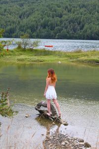 Woman in front of lake