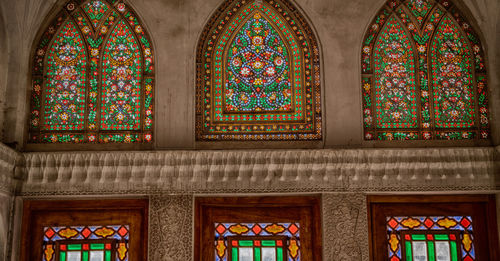 Low angle view of stained glass window in building