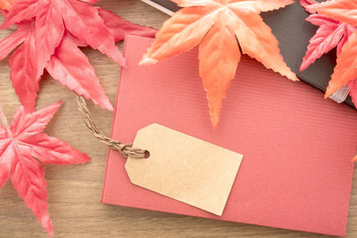 High angle view of label with envelope and maple leaves on table
