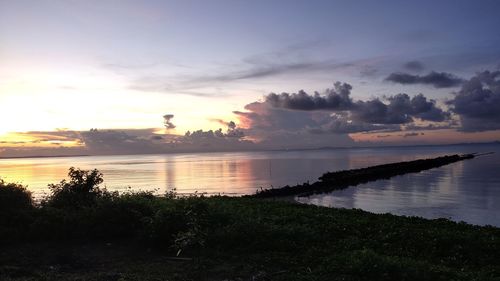 Scenic view of lake against sky during sunset