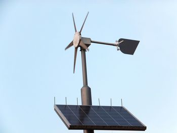 Low angle view of wind turbine against clear sky