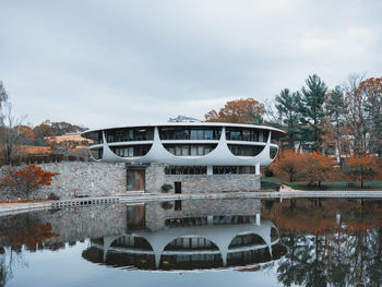 Arch bridge over lake against sky during autumn