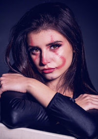 Portrait of beautiful woman with make up against black background