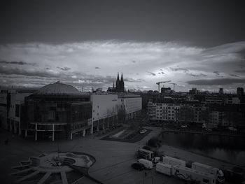 High angle view of buildings against cloudy sky