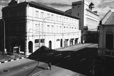 Empty road along buildings