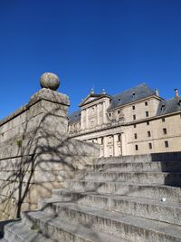 Low angle view of historical building against clear blue sky