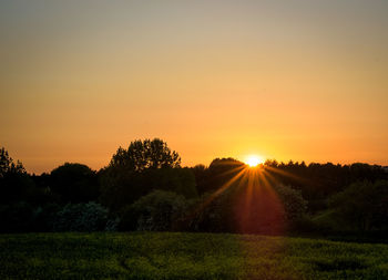 Scenic view of field against sky during sunset