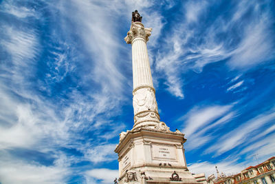 Low angle view of statue against blue sky