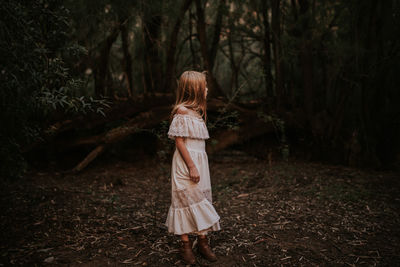 Girl in the woods looking over her shoulder