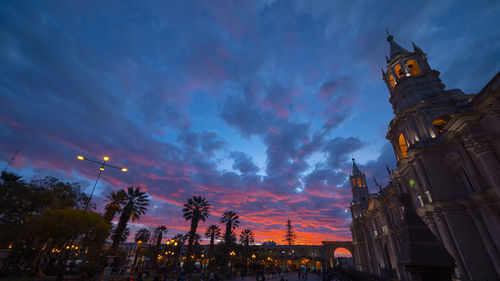 Low angle view of illuminated buildings at sunset