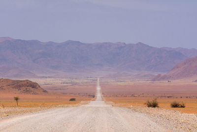 Road in desert against sky