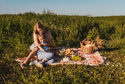 Woman sitting on grassy field