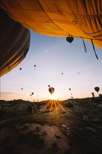 Close-up of hot air balloon flying over landscape