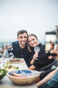 Happy young couple with food on table