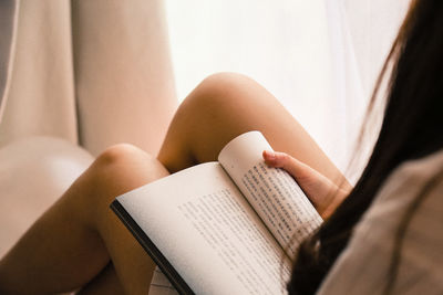 Close-up of woman reading book