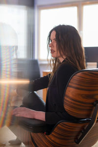 Businesswoman sitting on seat at office