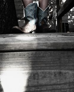 Woman standing on wooden plank