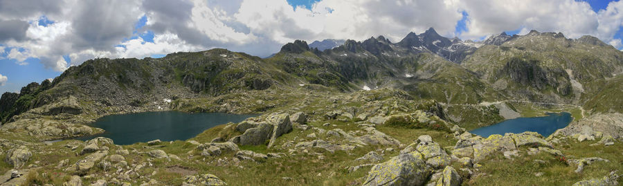 Scenic view of mountains and lake against cloudy sky