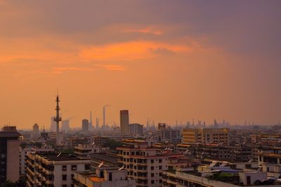 High angle view of buildings against cloudy sky during sunset