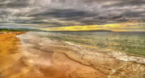 Scenic view of sea against cloudy sky