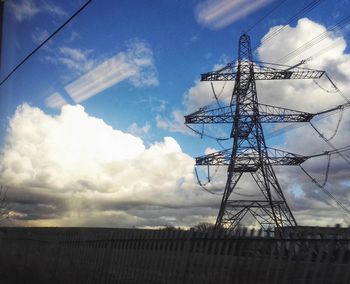 Low angle view of electricity pylon against sky