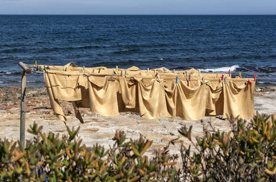 Napkins drying against sea