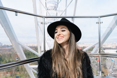 Portrait of smiling young woman in ferris wheel