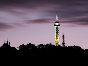 Low angle view of silhouette lighthouse against sky at dusk