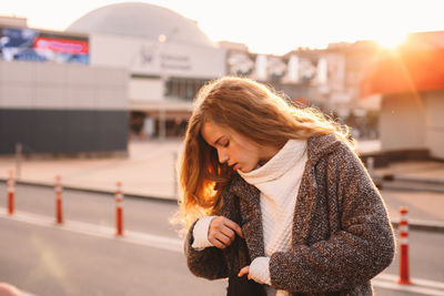 Young woman standing outdoors