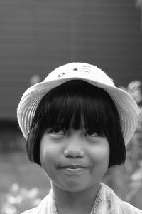 Close-up of girl looking up while wearing hat