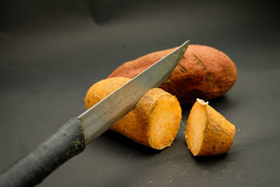 Close-up of orange and leaves on table