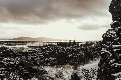 View of river against cloudy sky during winter